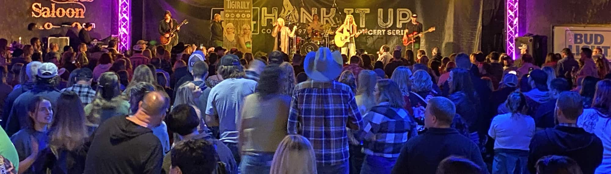 country concert with fans wearing cowboy hats Durham